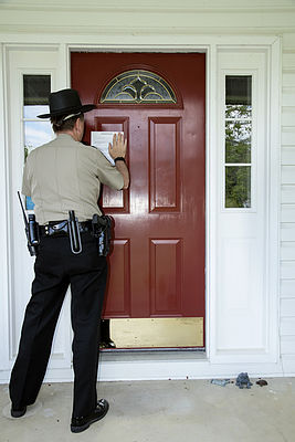 Law enforcement officer posting an evict